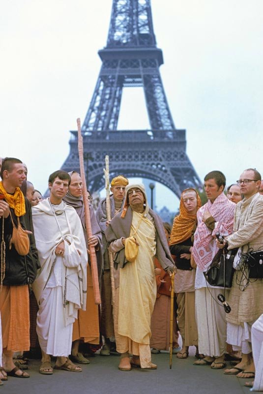 Srila Prabhupada standing near the Eiffel Tower in Paris